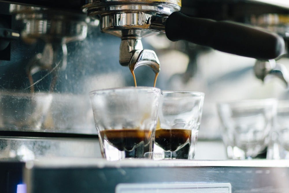 Coffee being made into two glasses